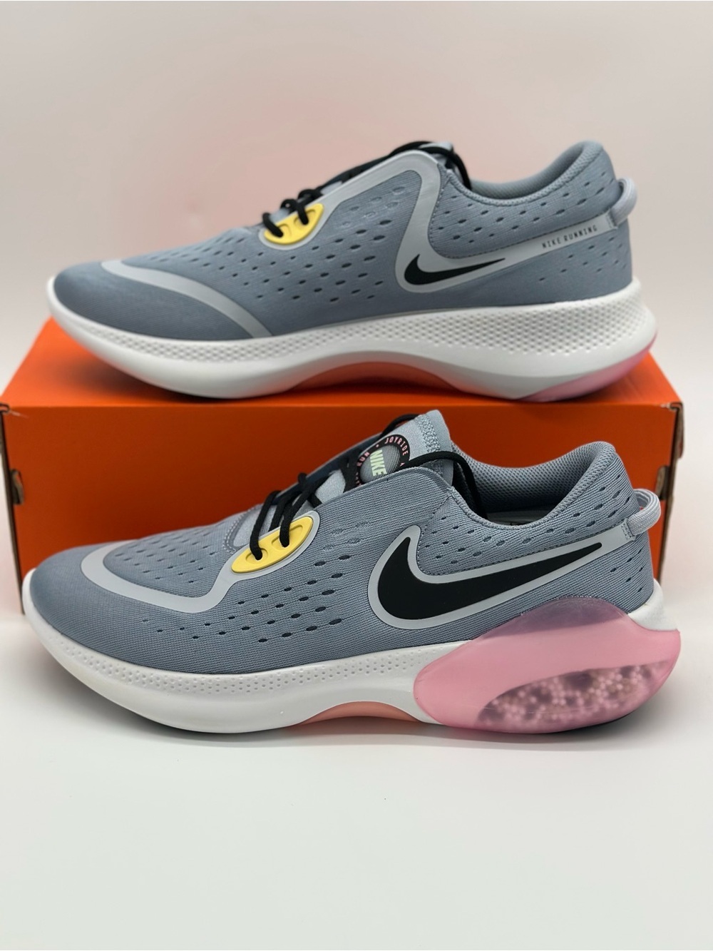 Nike Light Gray Running Sneakers with Black Swoosh and Pink & Yellow Accents
